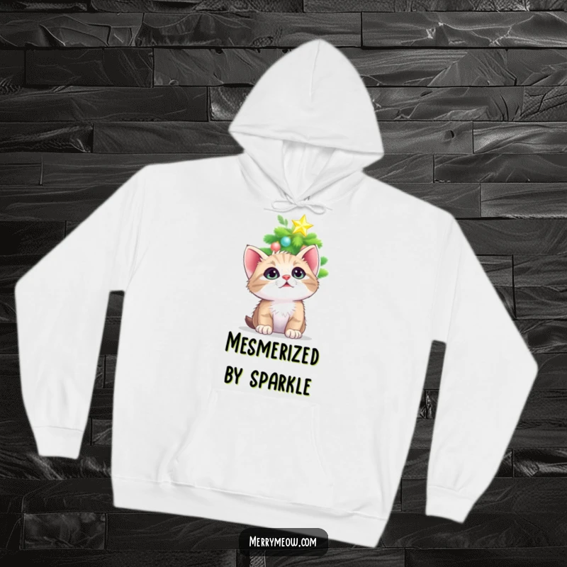 Funny hoodie featuring a cute kitten looking up with mesmerized eyes at a glowing, twinkling Christmas tree star, radiating cozy magic.