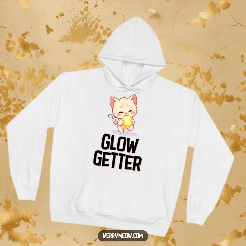 Funny hoodie showing a kitten happily chasing a glowing holiday ornament, designed for ultimate festive comfort.