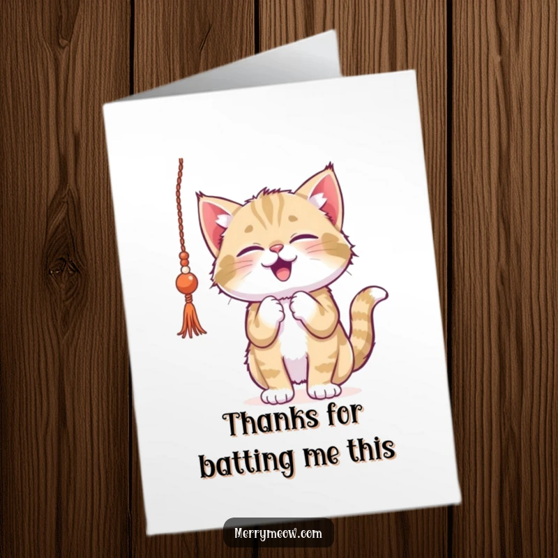 Funny free printable thank you card: a playful kitten batting gleefully at a strand of shiny tinsel.