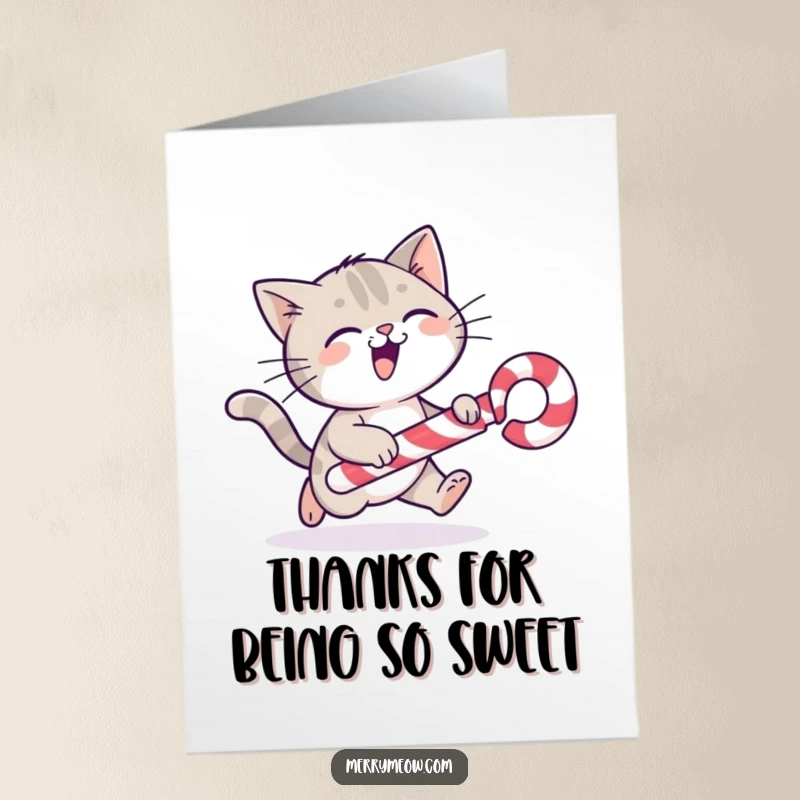 Funny Free Printable Thank You Card: A cat gleefully chases a rolling candy cane, expressing thanks.