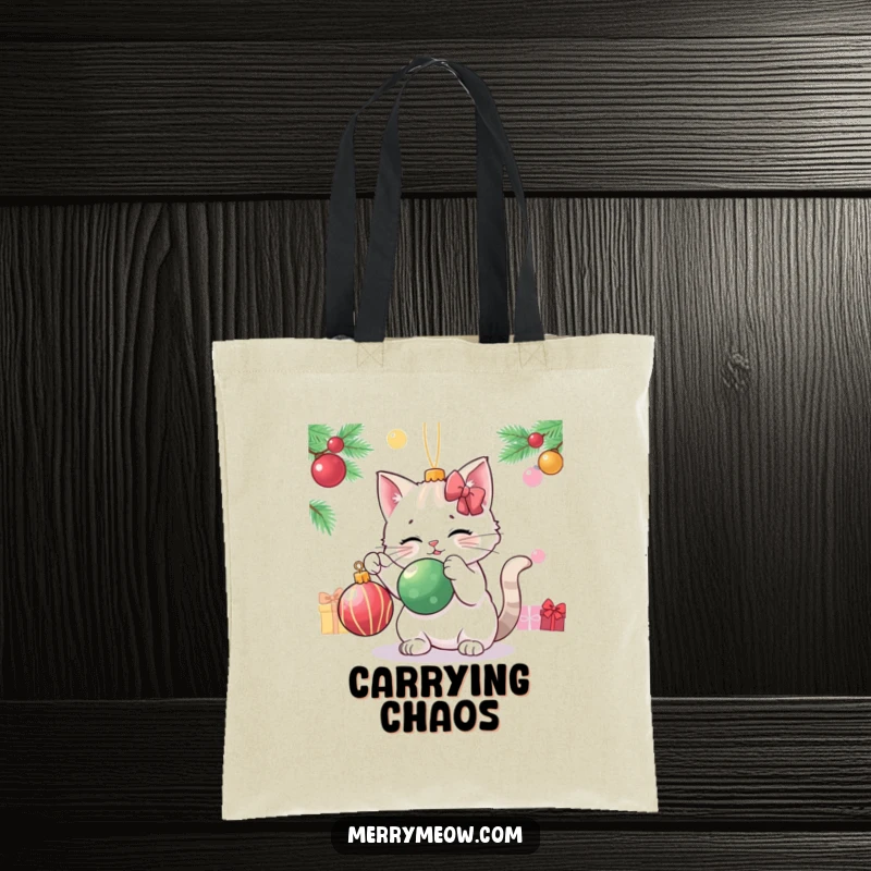 Funny cat playfully batting a Christmas ornament, depicted on a durable and festive tote bag.